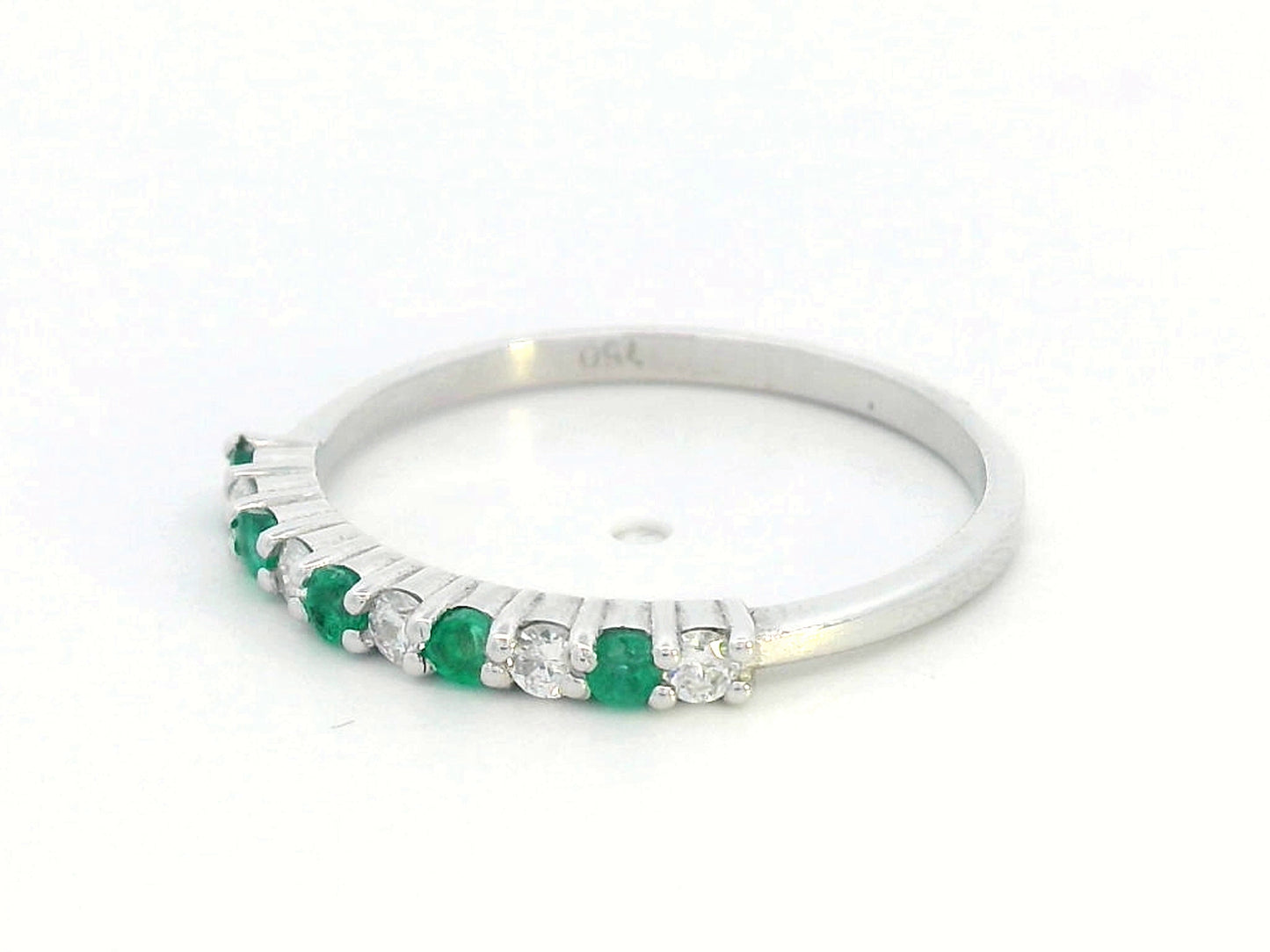 18K white gold half-eternity ring with alternating emeralds and diamonds, stackable wedding band design.