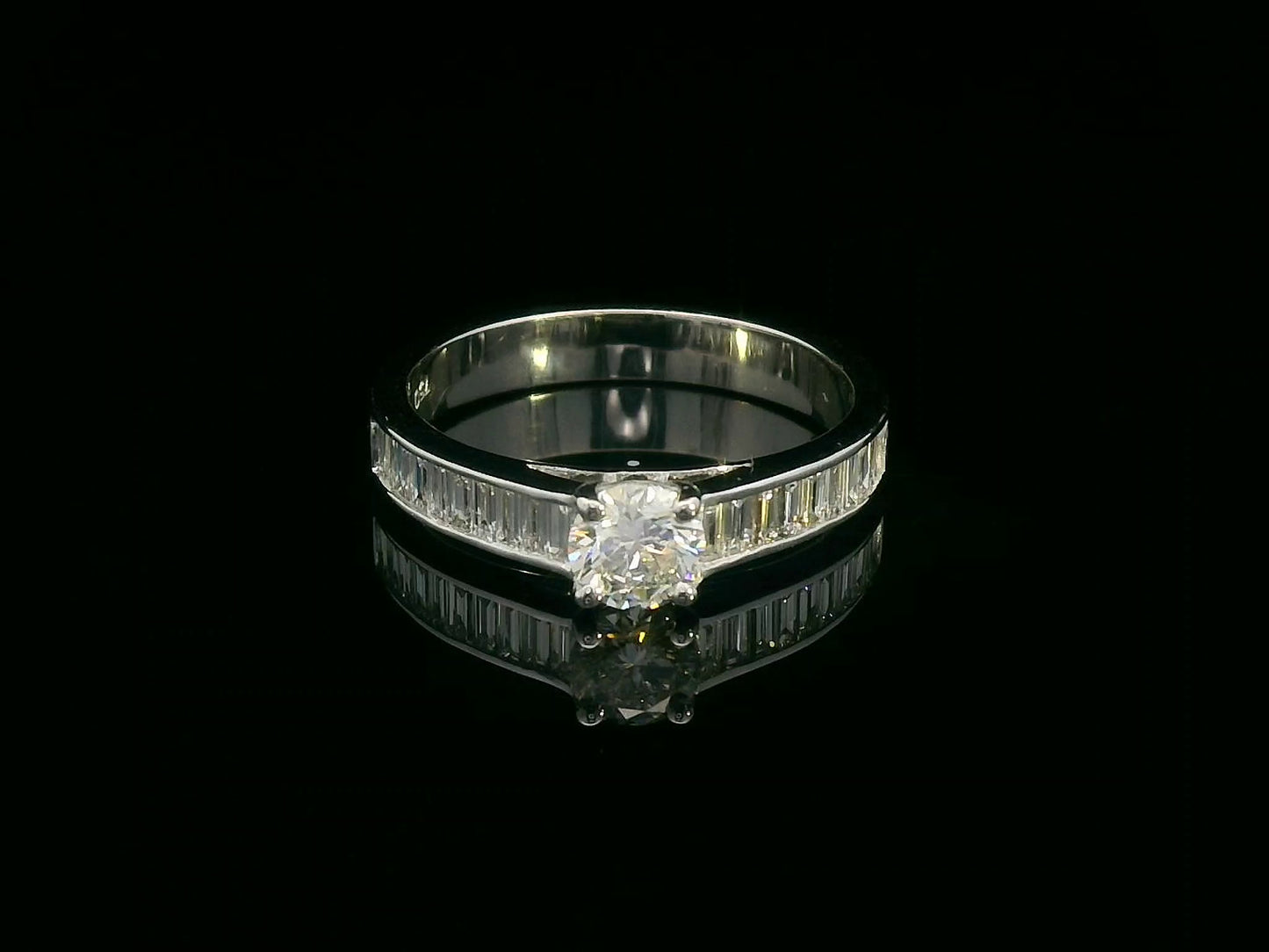 18K white gold engagement ring with round center diamond and baguette-cut side diamonds