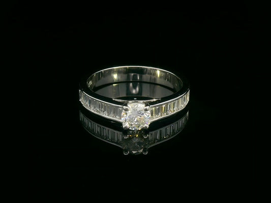 18K white gold engagement ring with round center diamond and baguette-cut side diamonds