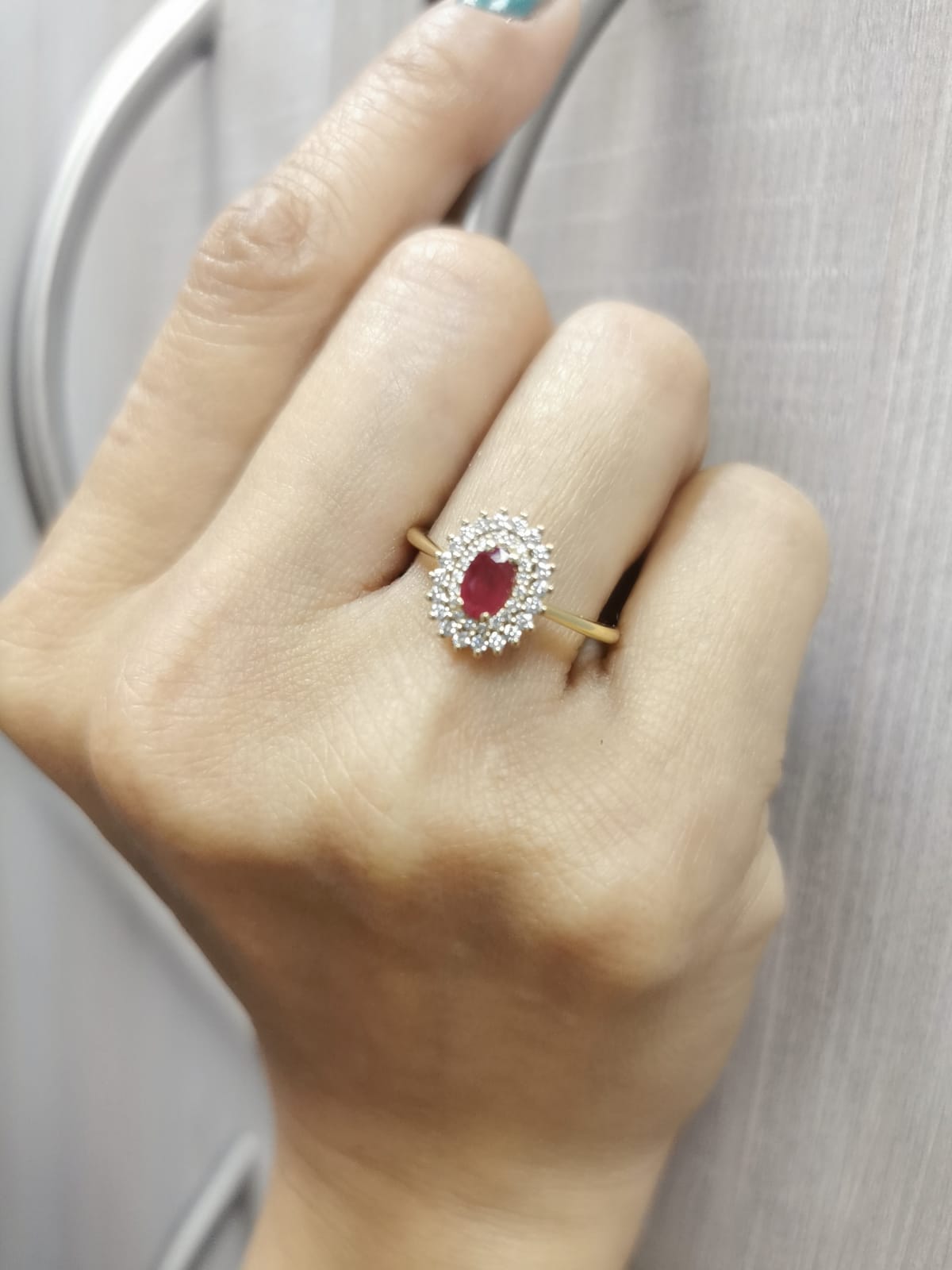 18K gold oval ruby and diamond halo ring with double halo design