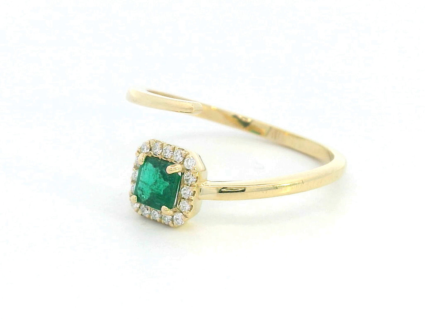 18K gold open-band ring with 0.38 carat emerald and diamond halo