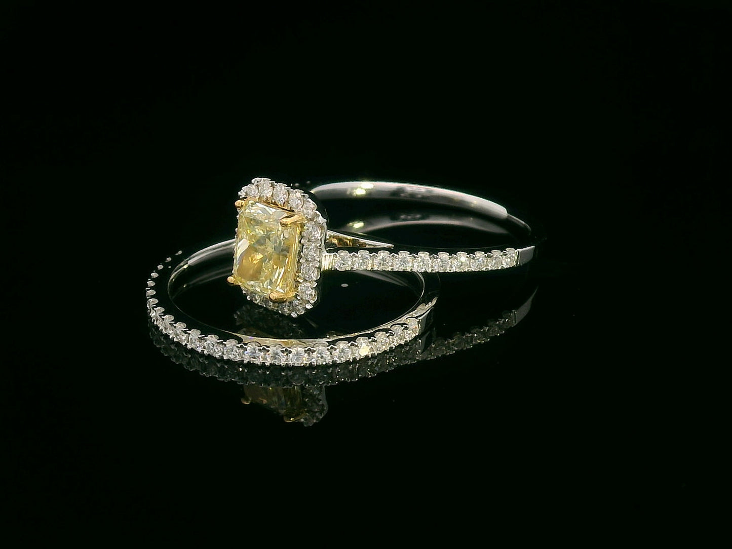 Bridal set with 1.08 carat radiant-cut fancy yellow diamond and 0.53 carat white diamonds in 18K gold