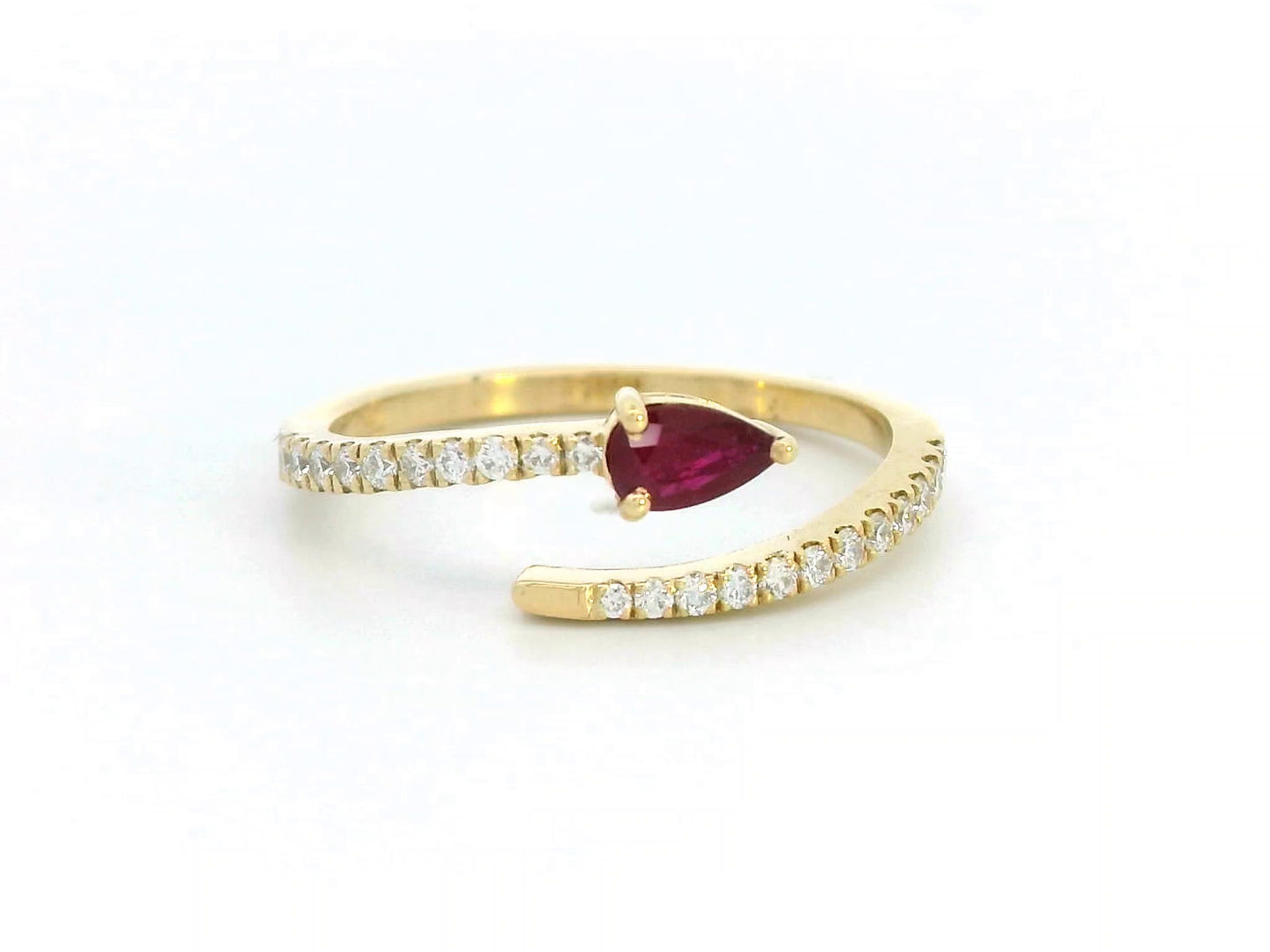 18K yellow gold bypass ring with pear-cut ruby and pavé-set diamonds in open design