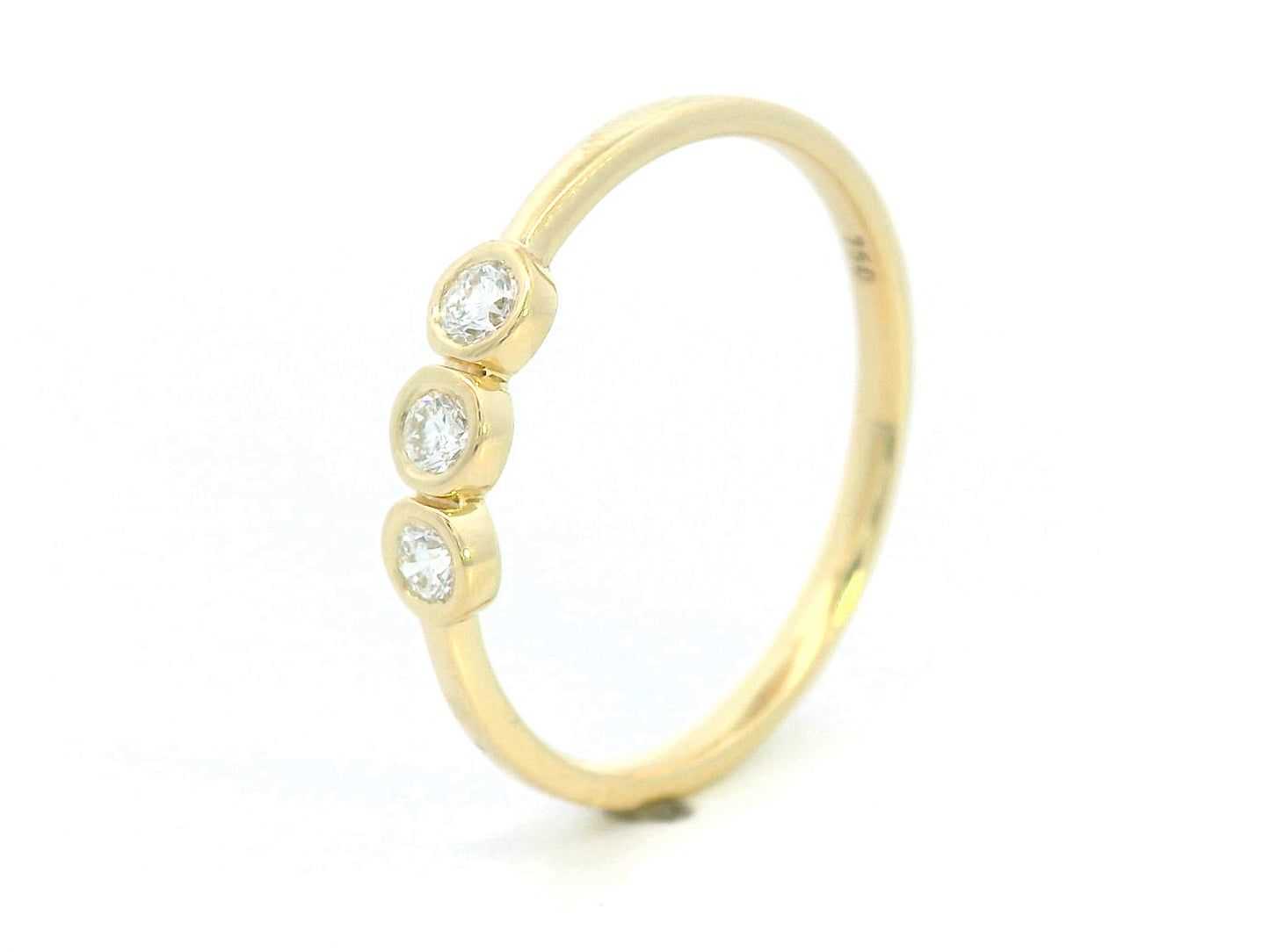 18K yellow gold trilogy ring with 0.18 carat bezel-set round diamonds, minimalist band design.