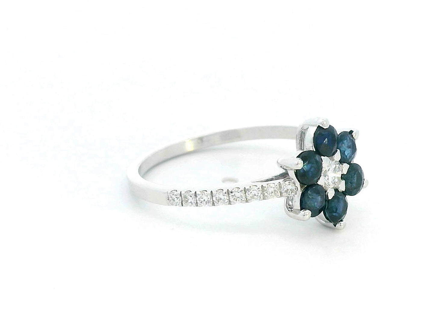 Floral ring in 18K gold with round blue sapphires and diamond center, pavé diamond band, total 0.91ct sapphires and 0.29ct diamonds.