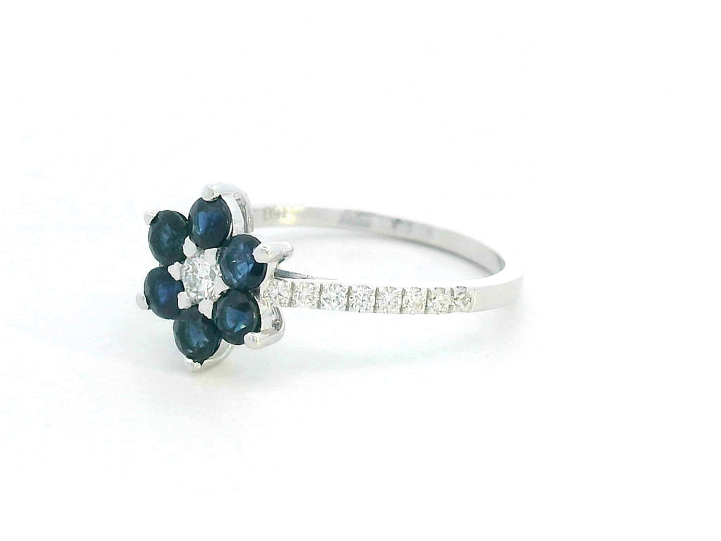 Floral ring in 18K gold with round blue sapphires and diamond center, pavé diamond band, total 0.91ct sapphires and 0.29ct diamonds.
