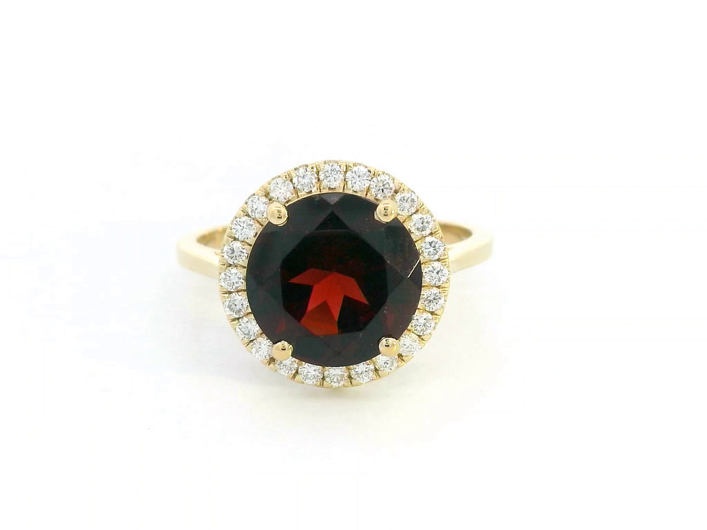 Round garnet and diamond halo ring in 18K yellow gold featuring a 3.85 carat garnet and 0.27 carats of diamonds.