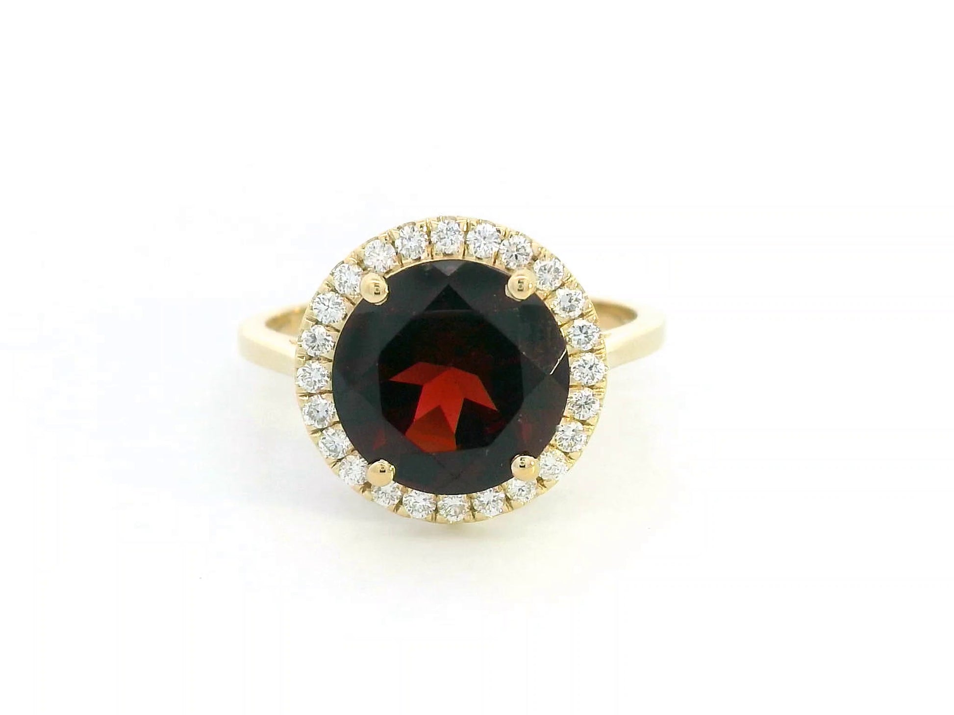Round garnet and diamond halo ring in 18K yellow gold featuring a 3.85 carat garnet and 0.27 carats of diamonds.