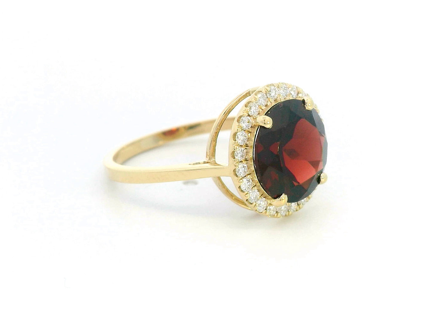 Round garnet and diamond halo ring in 18K yellow gold featuring a 3.85 carat garnet and 0.27 carats of diamonds.