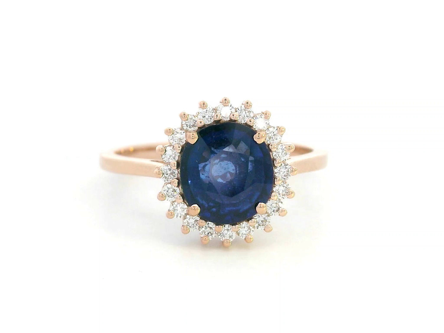 Blue sapphire and diamond halo ring in 18K rose gold with 2.02 carat sapphire and vintage-inspired setting
