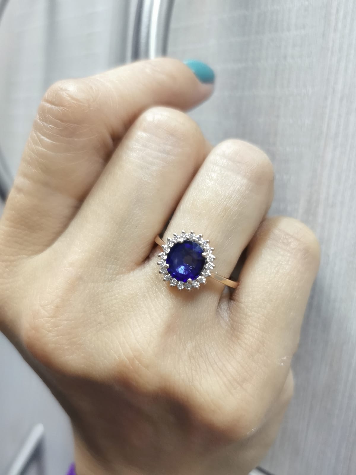 Blue sapphire and diamond halo ring in 18K rose gold with 2.02 carat sapphire and vintage-inspired setting