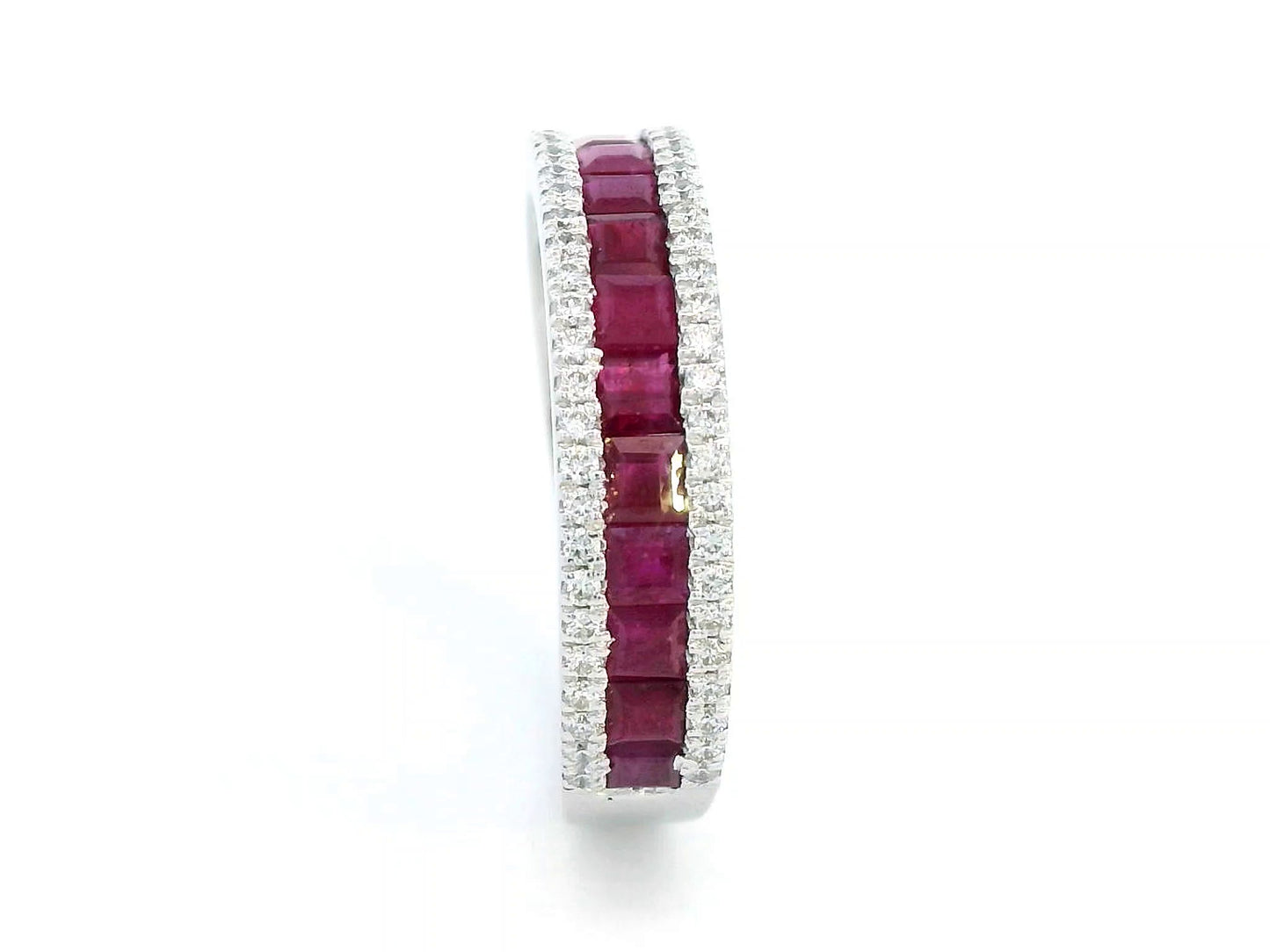 18K gold ruby and diamond ring with 1.36ct baguette-cut rubies and 0.26ct round diamonds in modern channel setting.
