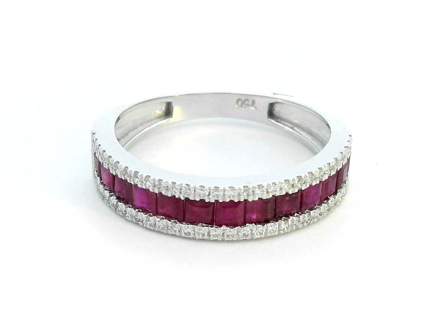 18K gold ruby and diamond ring with 1.36ct baguette-cut rubies and 0.26ct round diamonds in modern channel setting.