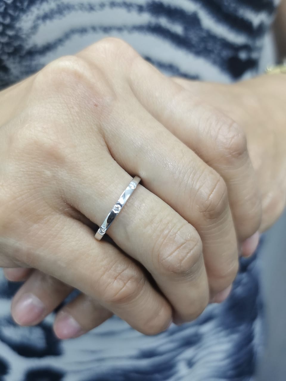 18K gold diamond band ring with flush-set round diamonds in a minimalist design