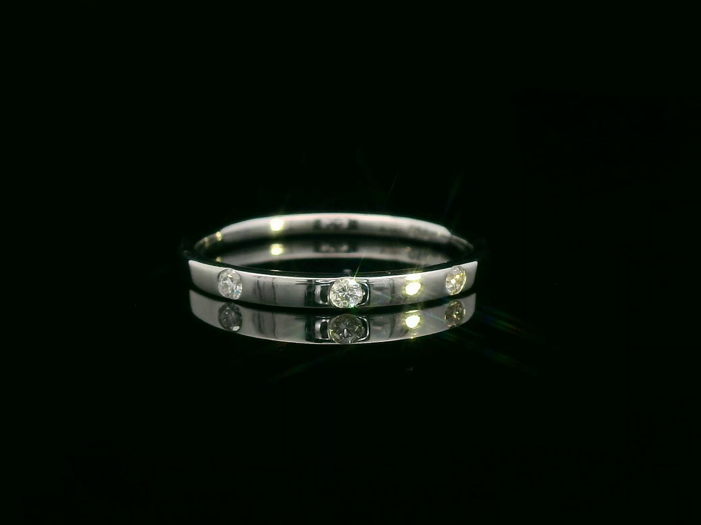 18K gold diamond band ring with flush-set round diamonds in a minimalist design