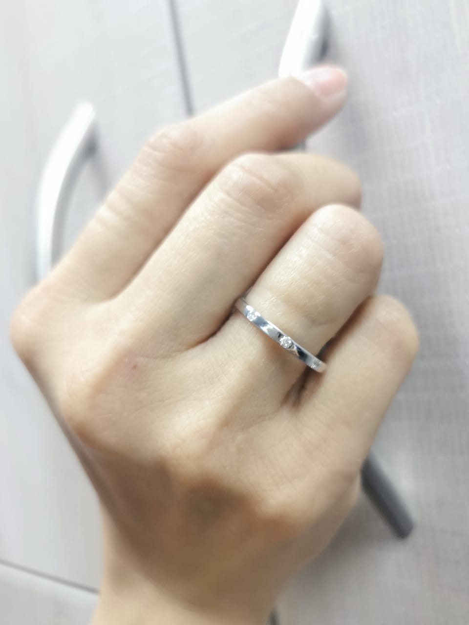 18K gold diamond band ring with flush-set round diamonds in a minimalist design
