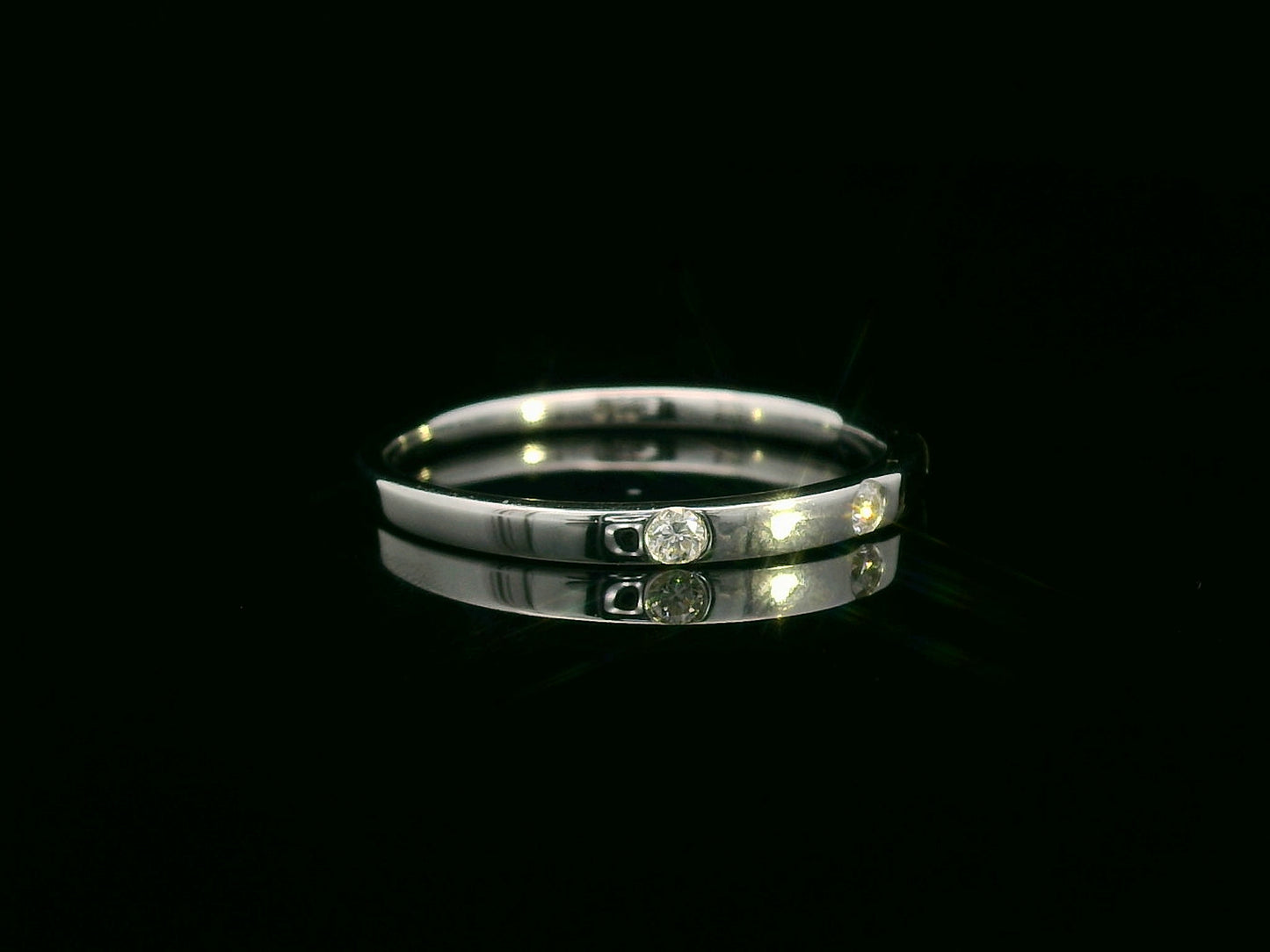 18K gold diamond band ring with flush-set round diamonds in a minimalist design