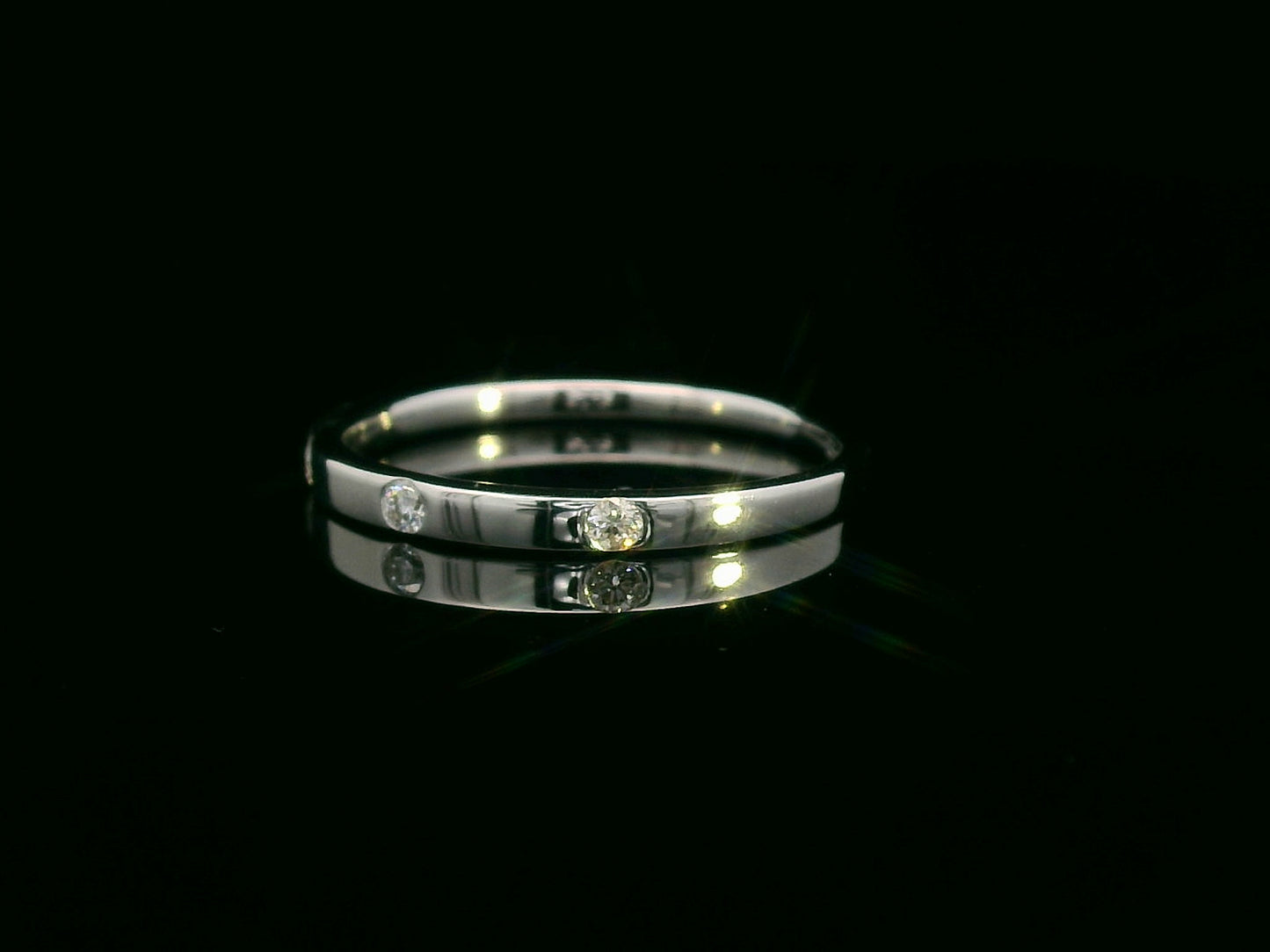 18K gold diamond band ring with flush-set round diamonds in a minimalist design