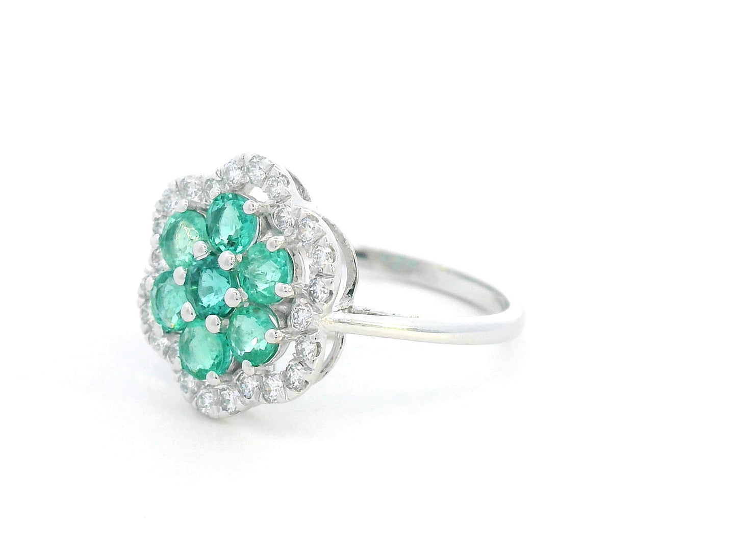 Floral emerald cluster and diamond halo ring in 18K gold