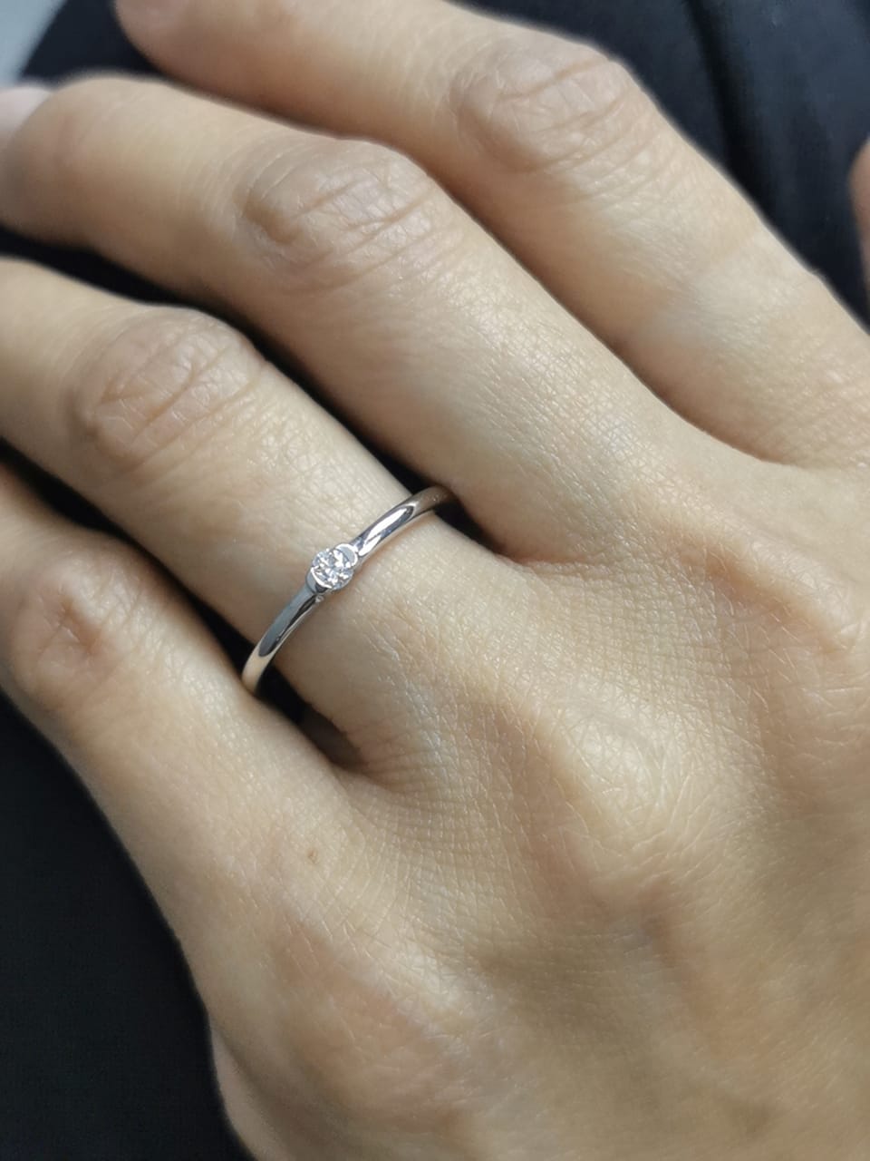 Modern minimalist tension-set diamond ring in 18K gold with 0.10ct solitaire