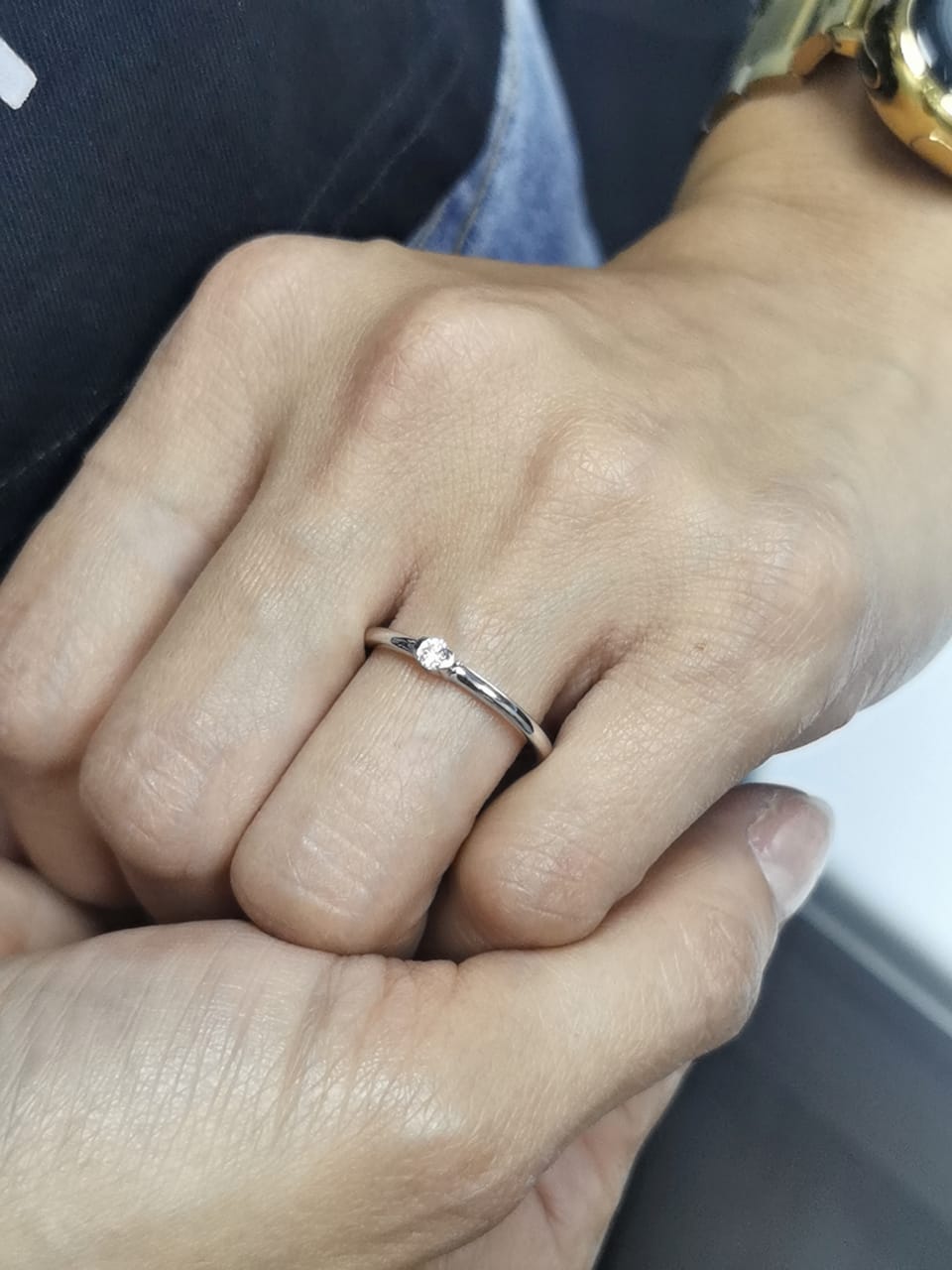 Modern minimalist tension-set diamond ring in 18K gold with 0.10ct solitaire