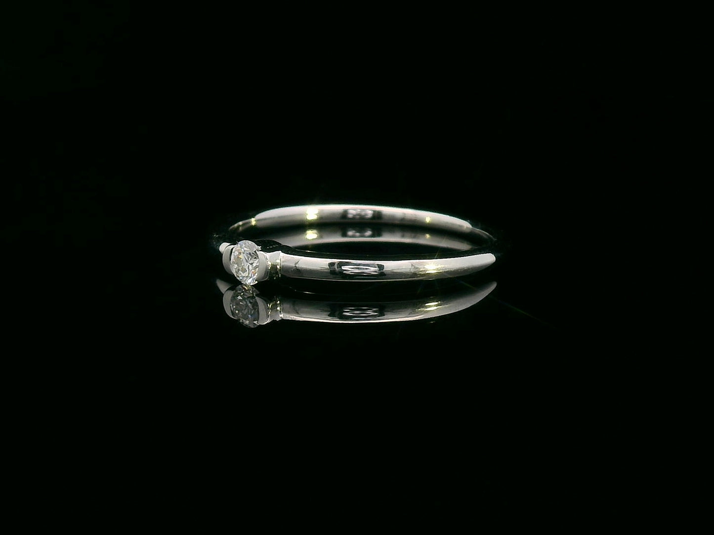 Modern minimalist tension-set diamond ring in 18K gold with 0.10ct solitaire