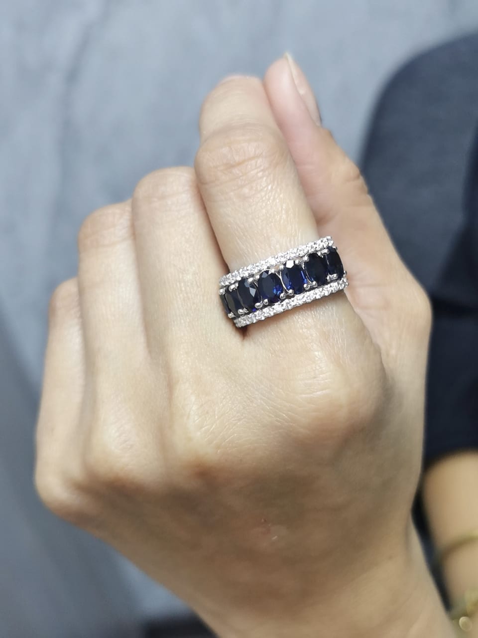 18K white gold wide band ring with oval blue sapphires and round diamond borders – Emirates Diamonds