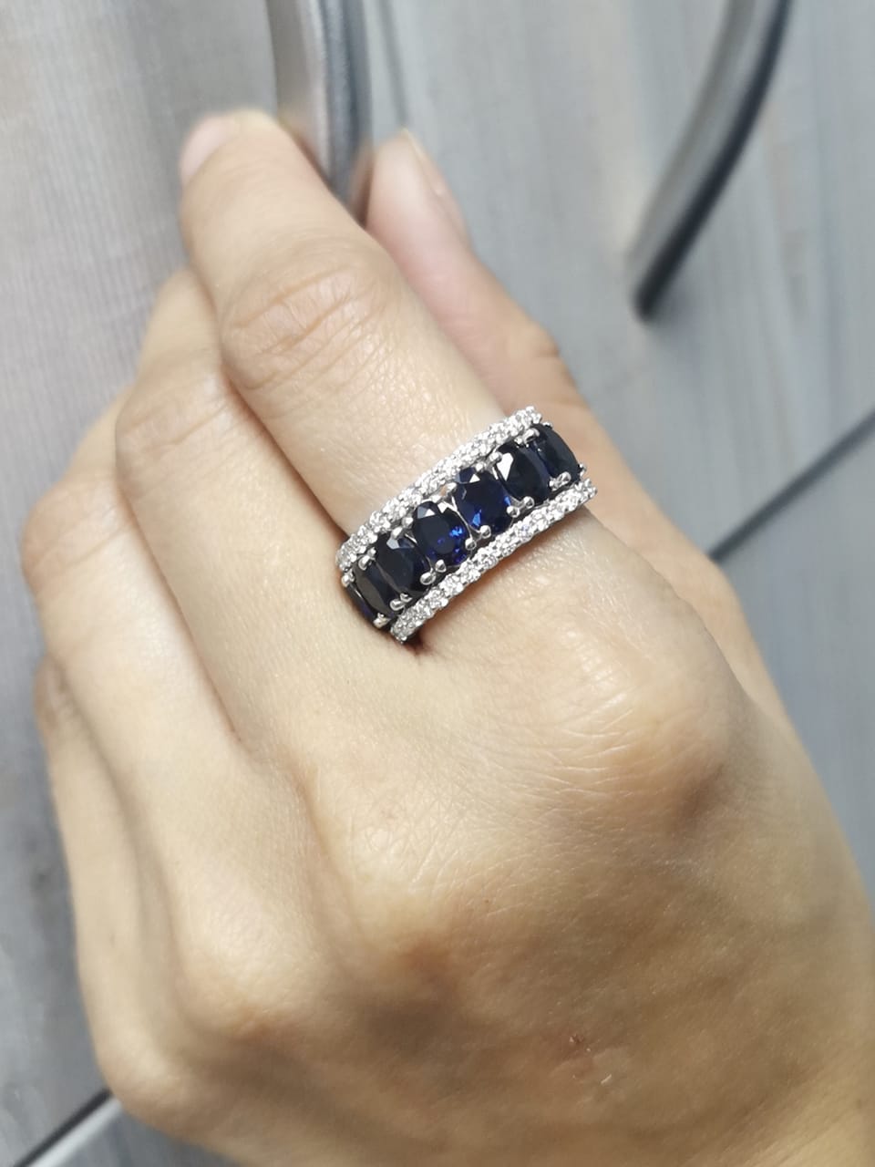 18K white gold wide band ring with oval blue sapphires and round diamond borders – Emirates Diamonds