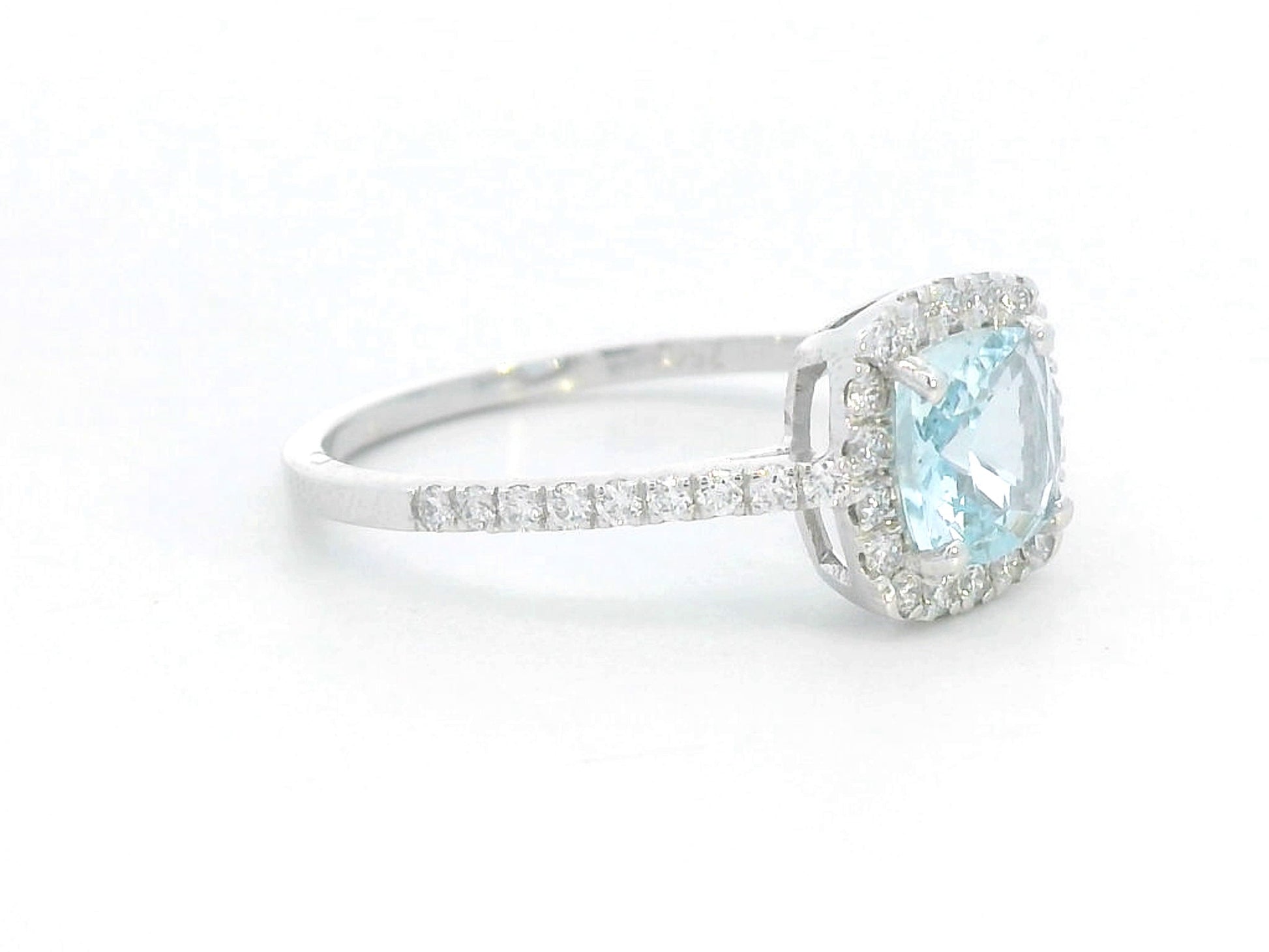 18K white gold ring with cushion-cut aquamarine center and diamond halo and band