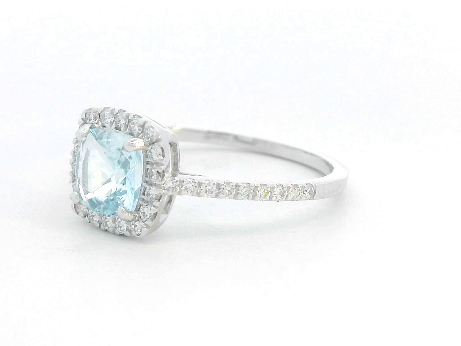 18K white gold ring with cushion-cut aquamarine center and diamond halo and band