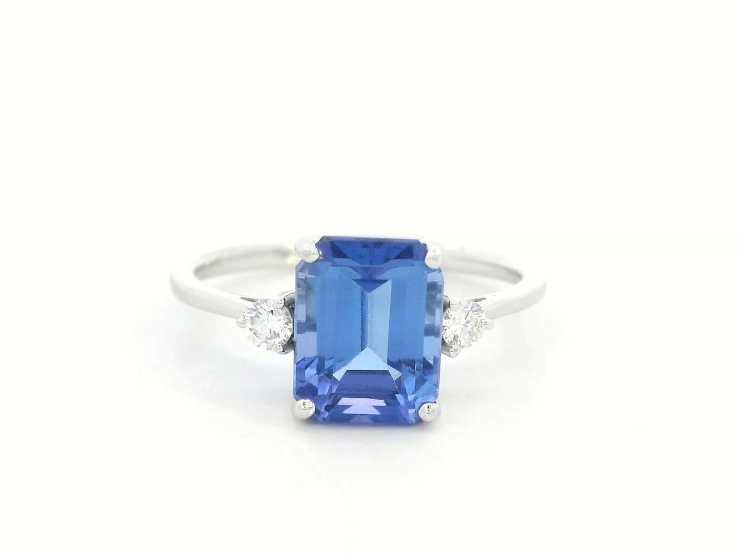 18K white gold ring with 3.08 carat emerald-cut Tanzanite and round diamond accents on the sides