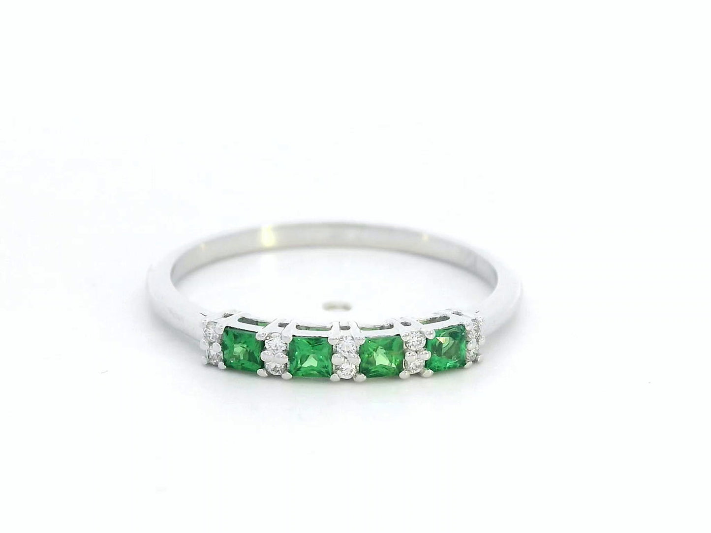 18K white gold ring with square-cut tsavorites and alternating round diamonds in a half eternity band