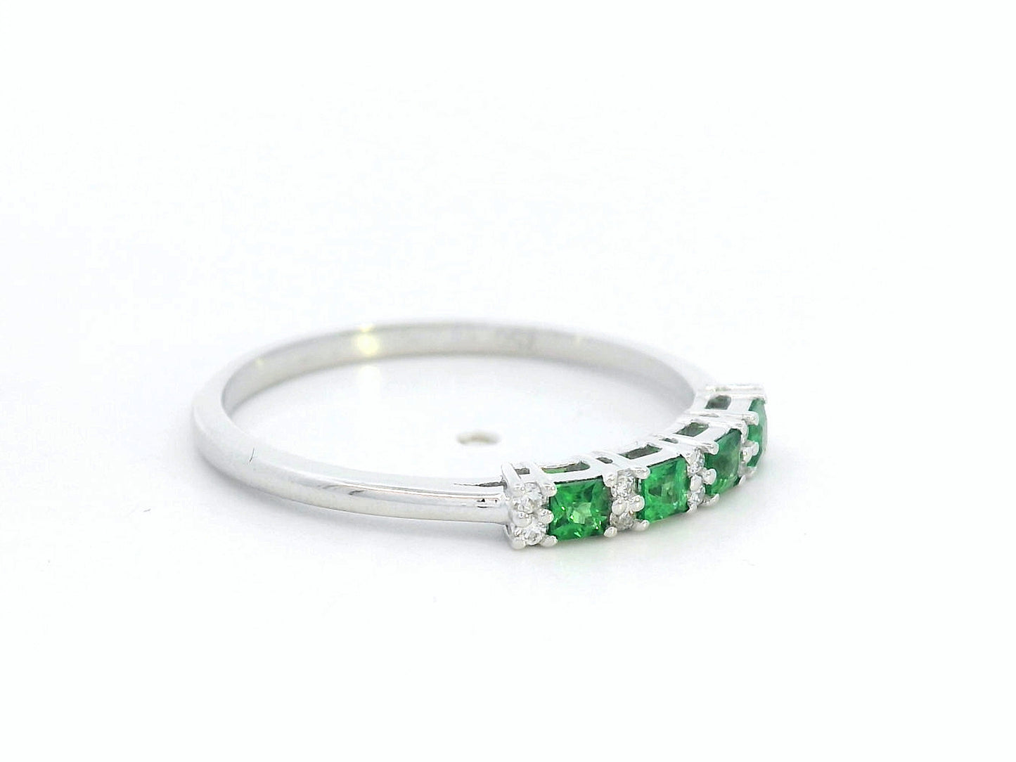 18K white gold ring with square-cut tsavorites and alternating round diamonds in a half eternity band