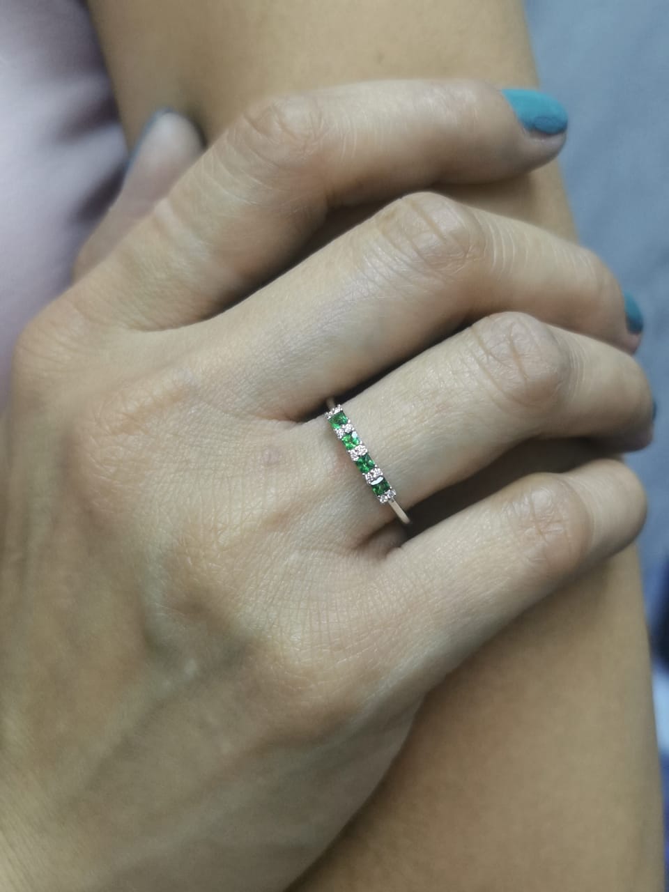 18K white gold ring with square-cut tsavorites and alternating round diamonds in a half eternity band