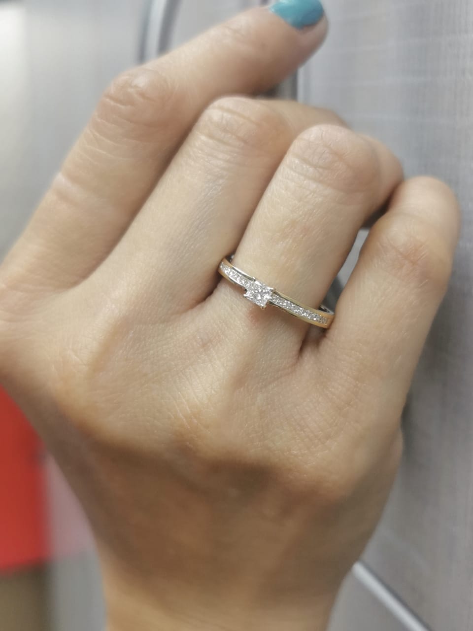 18K gold ring with a 0.24 carat princess-cut diamond and 0.27 carats of channel-set princess-cut diamonds on the band