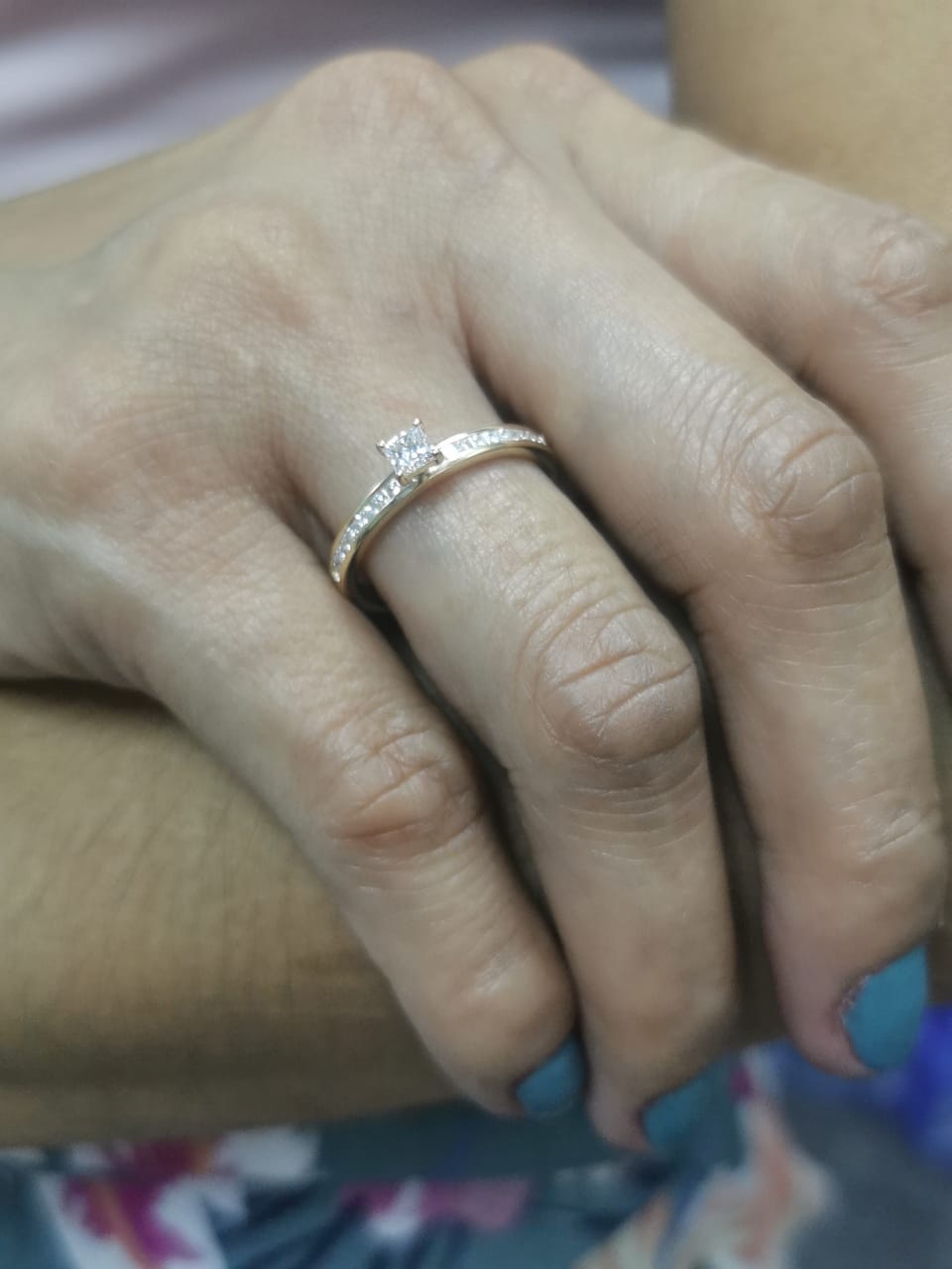 18K gold ring with a 0.24 carat princess-cut diamond and 0.27 carats of channel-set princess-cut diamonds on the band