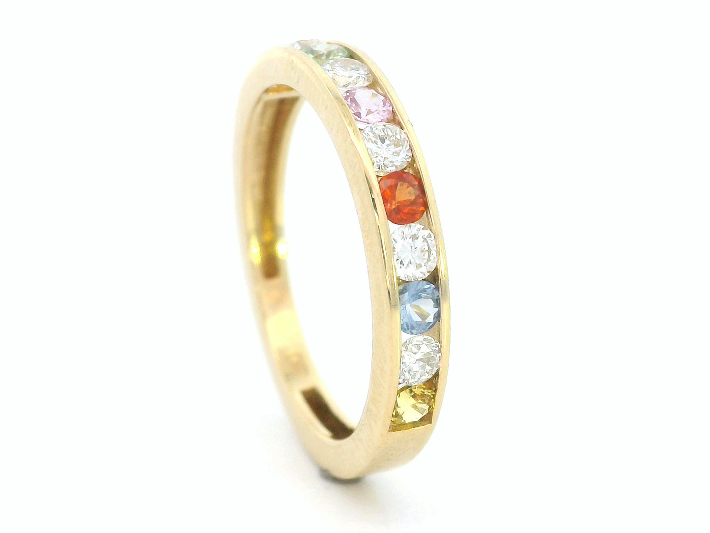 18K yellow gold band with alternating multi-color sapphires and round-cut diamonds in a channel setting