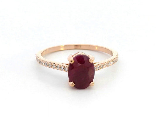 18K rose gold ring featuring a 1.92 carat oval-cut ruby with diamond band