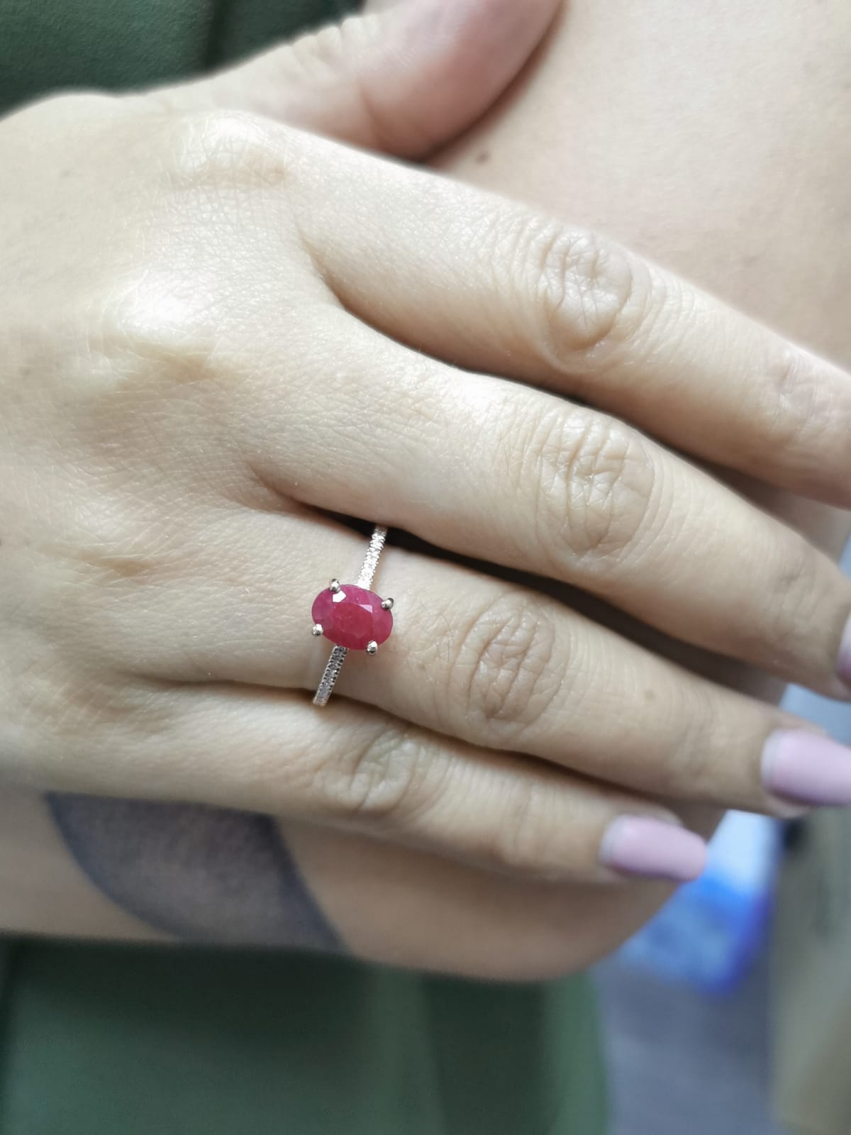 18K rose gold ring featuring a 1.92 carat oval-cut ruby with diamond band