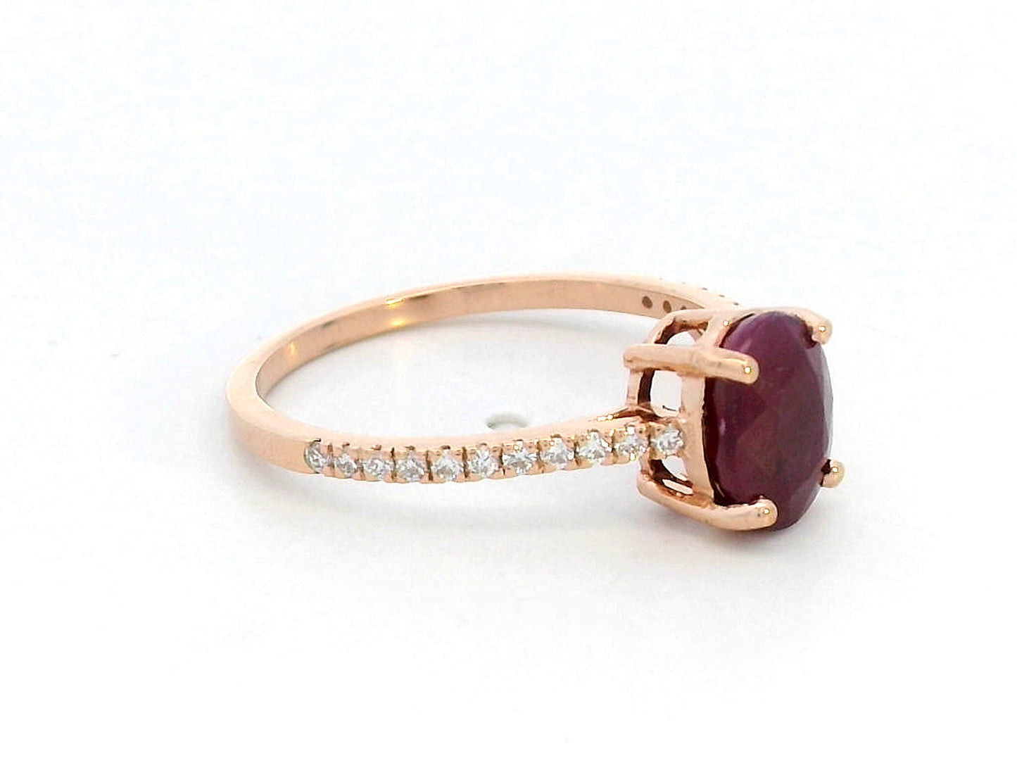 18K rose gold ring featuring a 1.92 carat oval-cut ruby with diamond band