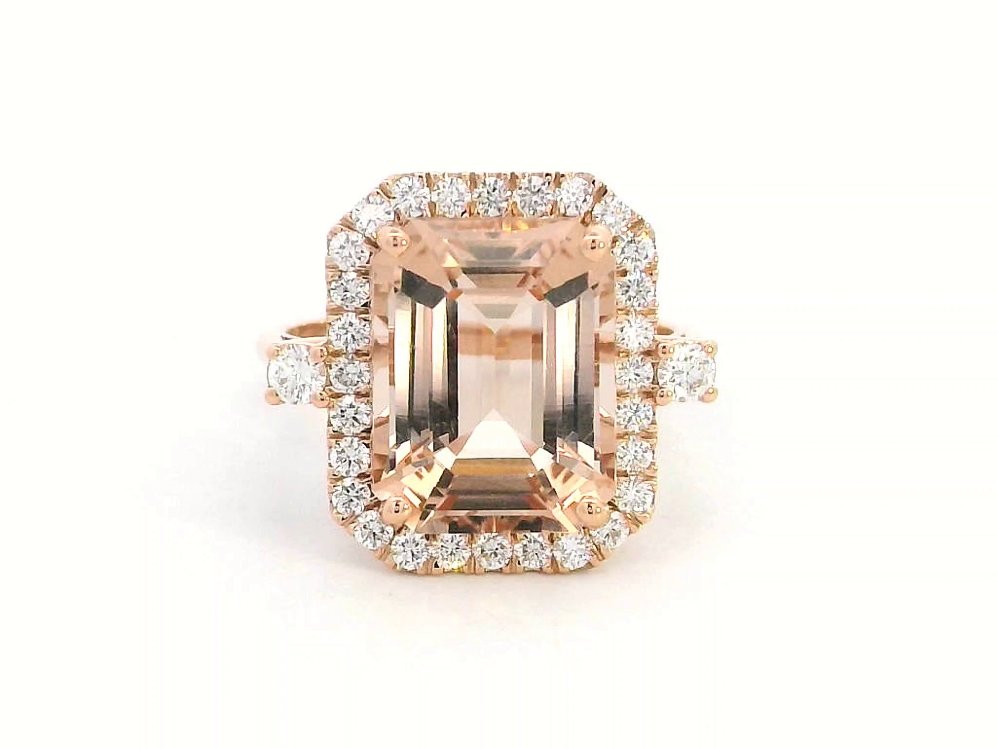 Emerald-cut morganite halo ring with round diamonds in 18K rose gold