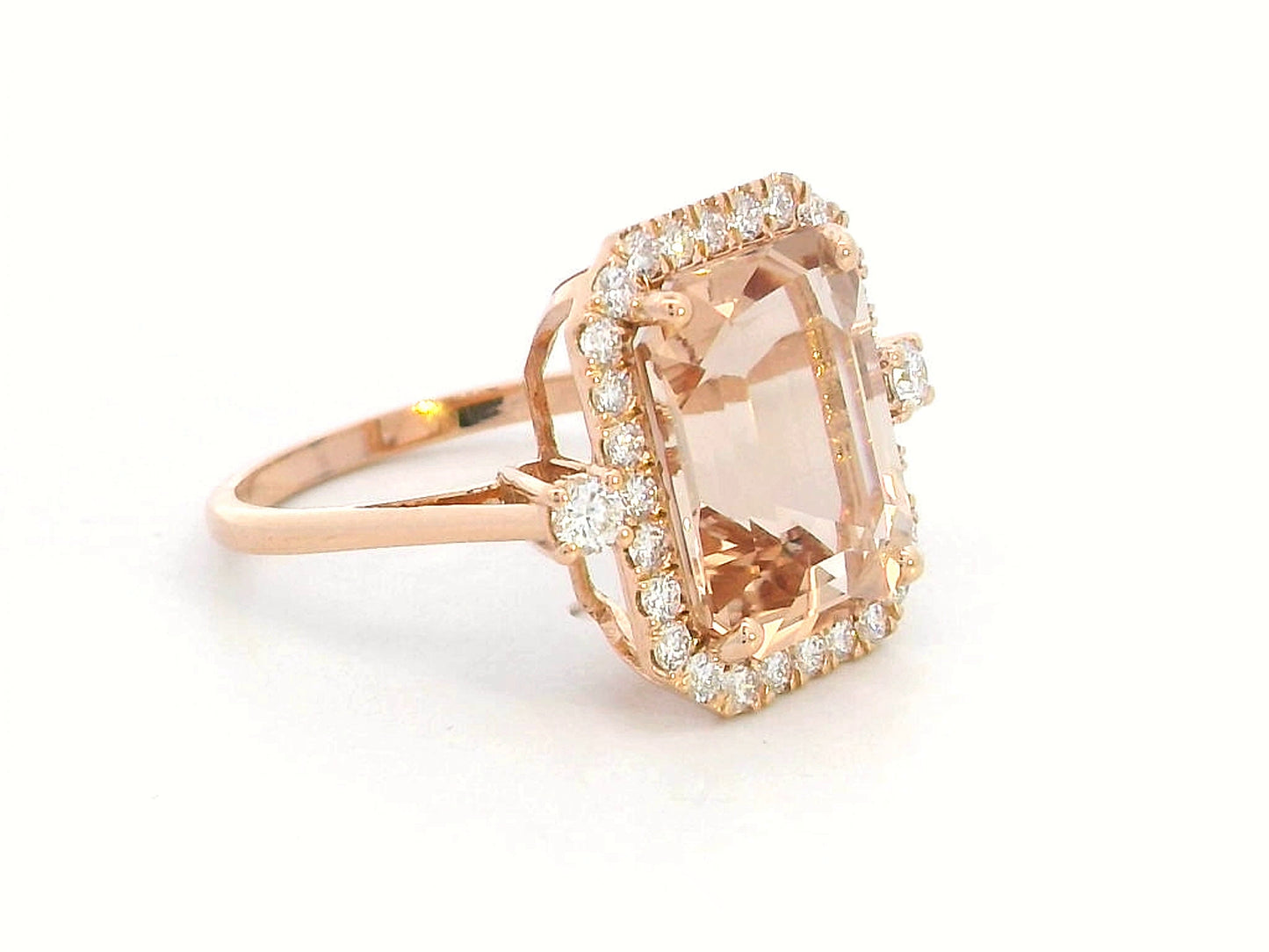 Emerald-cut morganite halo ring with round diamonds in 18K rose gold