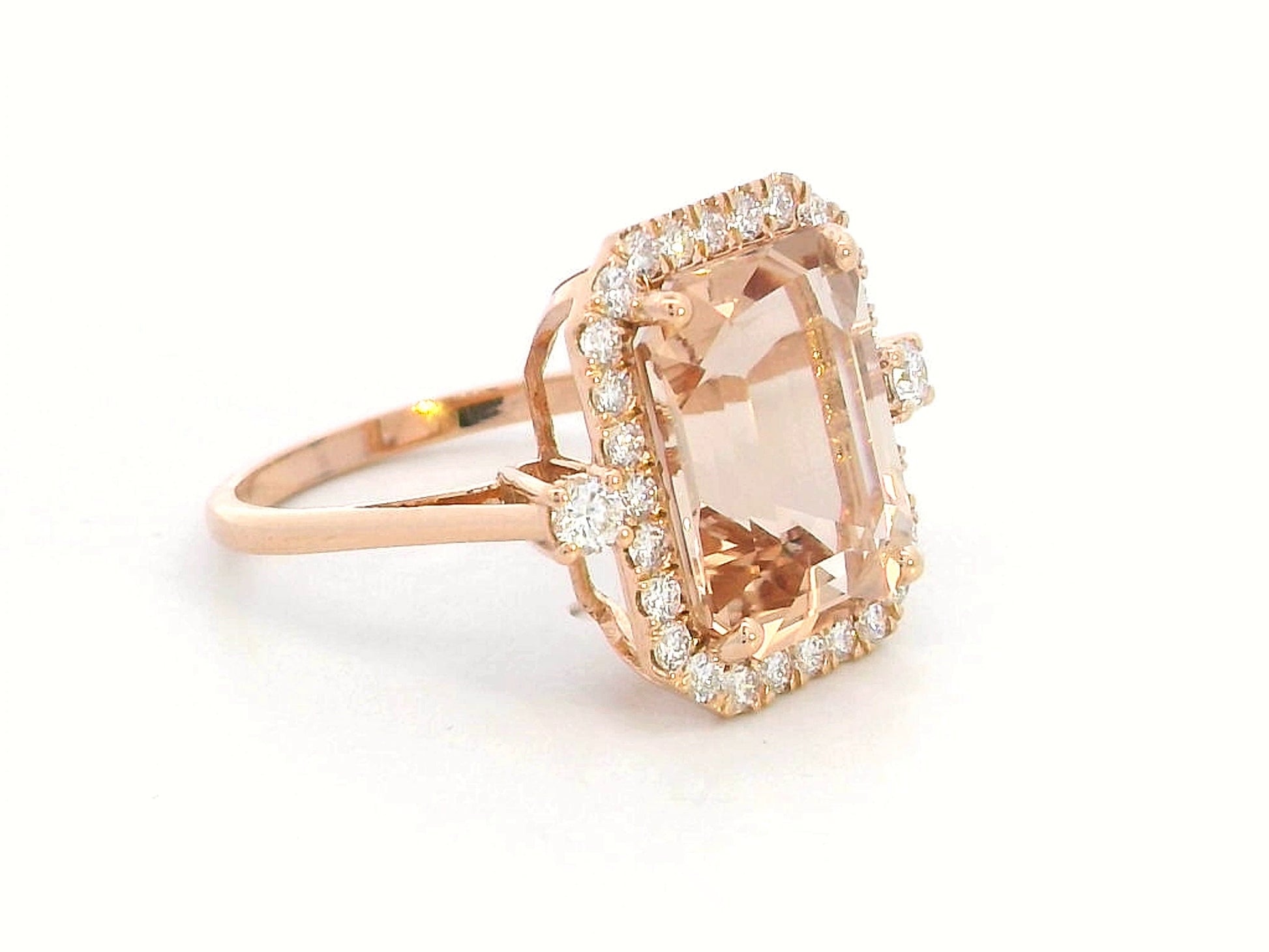Emerald-cut morganite halo ring with round diamonds in 18K rose gold
