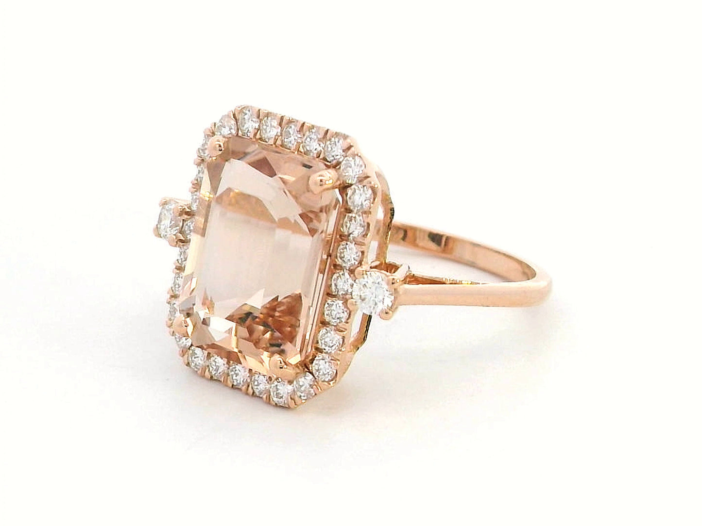 Emerald-cut morganite halo ring with round diamonds in 18K rose gold