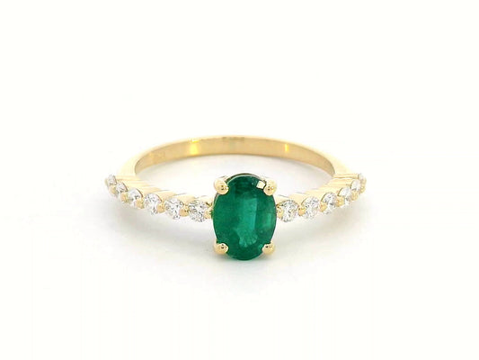 18K yellow gold ring with oval-cut emerald center and round diamond accents on the band