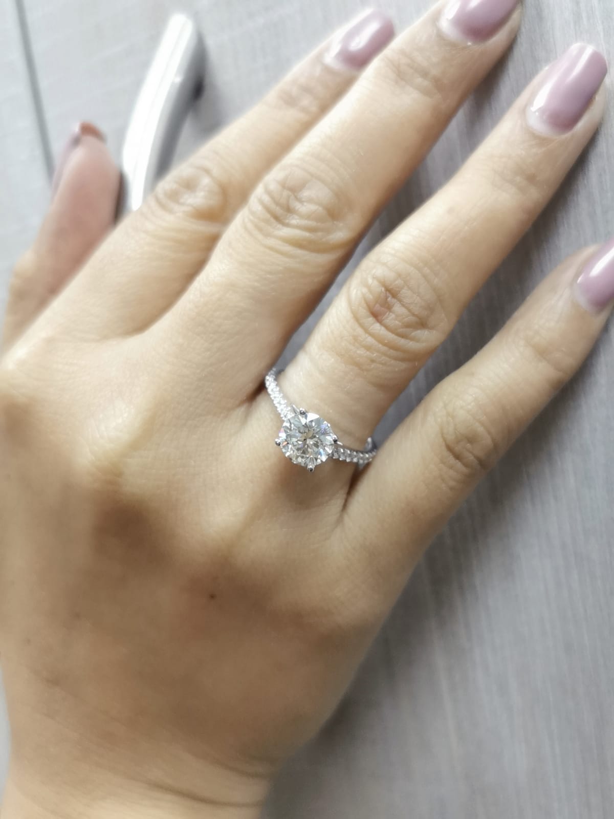 18K white gold engagement ring with 1.86 carat round diamond and 0.31 carats of accent diamonds on the band
