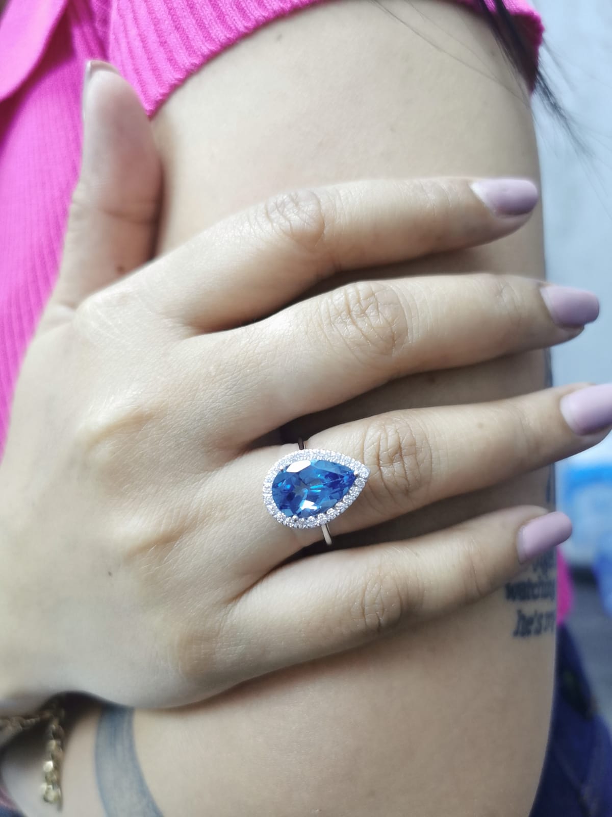 18K white gold ring with 5.26 carat pear-cut London Blue Topaz and diamond halo