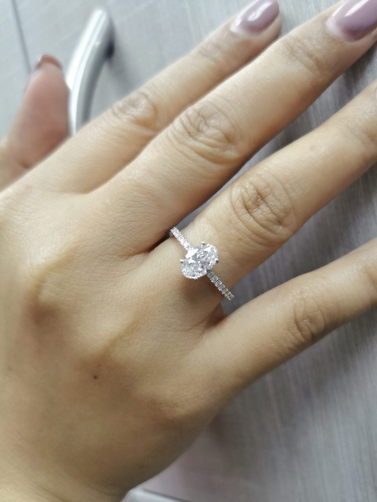 18K white gold oval diamond engagement ring with round diamonds along band – 1.01 carat D color center stone, IGI certified