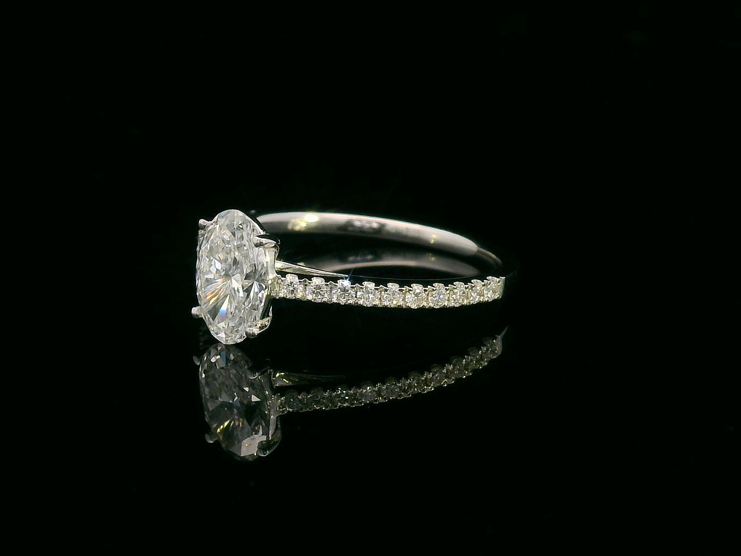 18K white gold oval diamond engagement ring with round diamonds along band – 1.01 carat D color center stone, IGI certified