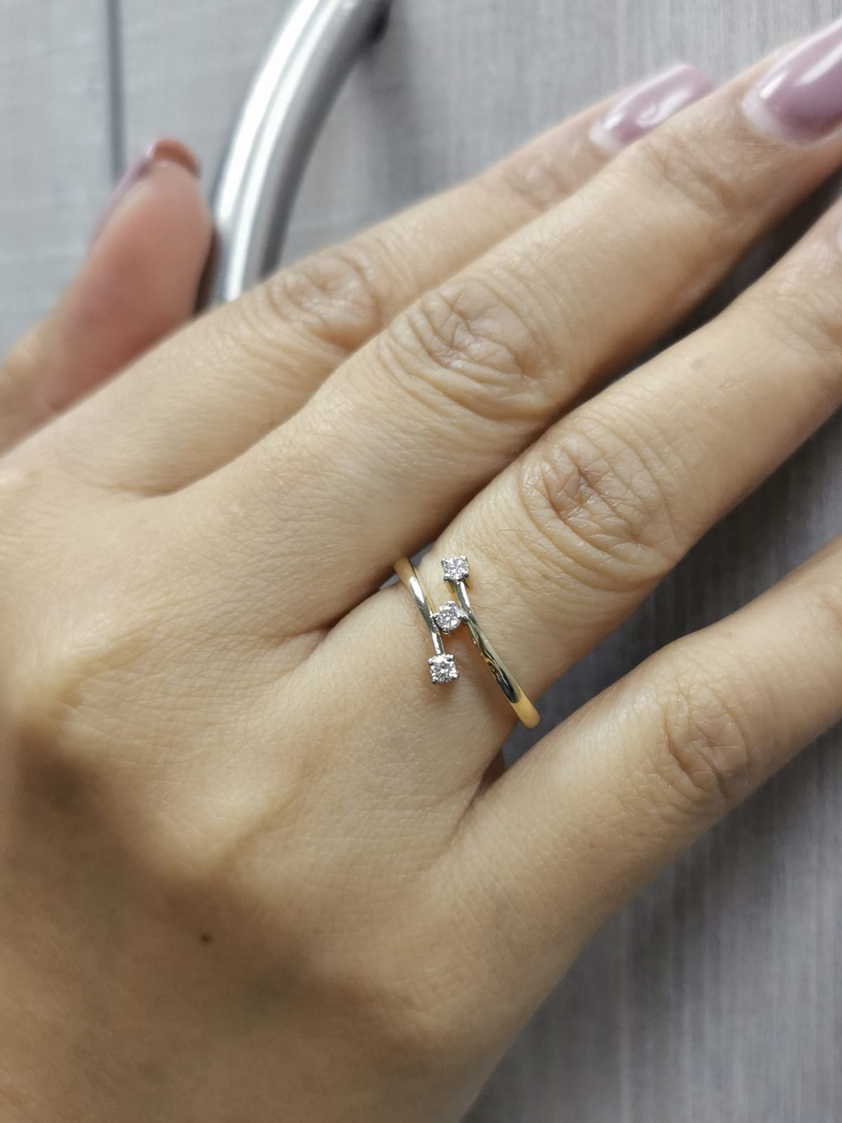 18K gold open bypass ring with three round diamonds totaling 0.13ct, minimalist modern design